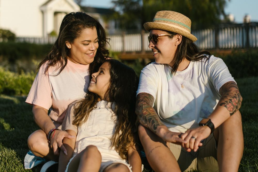 Native American Indigenous Family having fun in front of a light house by the beach