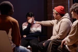 Man in group therapy session for chronic relapse.