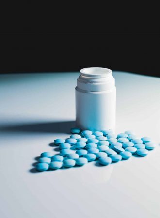 blue pills outside of pill bottle - blues drugs